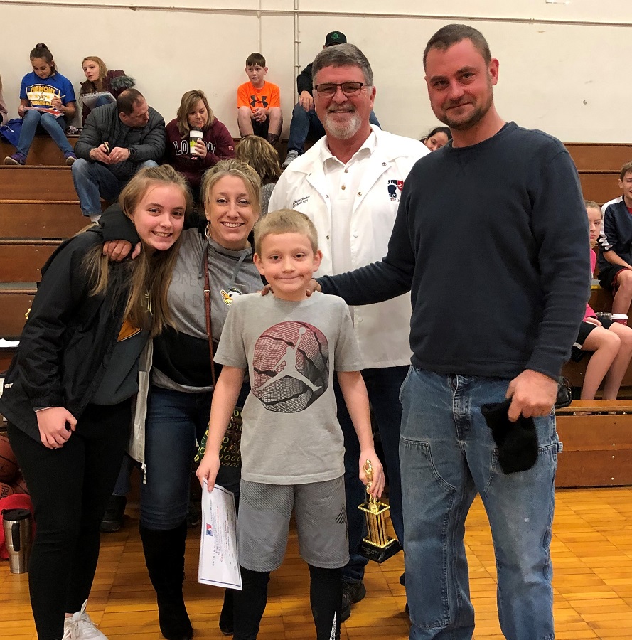 190112 Hoop Shoot 2 Ryder Kahler of Melrose Elementary 8 9 year old with Hoop Shoot Director Joel Buoy and happy family